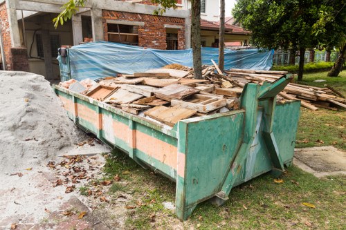 Construction site managing waste in Raynes Park